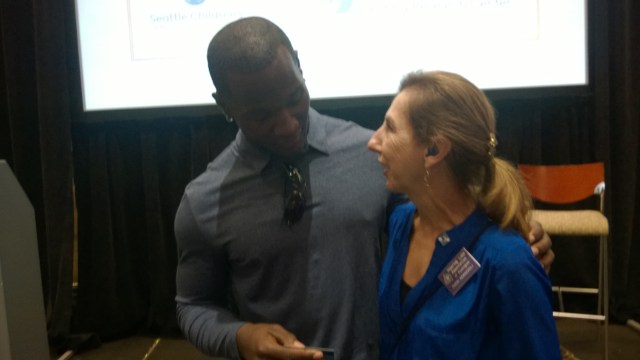 Derrick Coleman with Let's Loop Seattle founder Cheri Perazzoli.